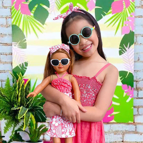 18 inch doll in Travel outfit shown with child wearing accessory